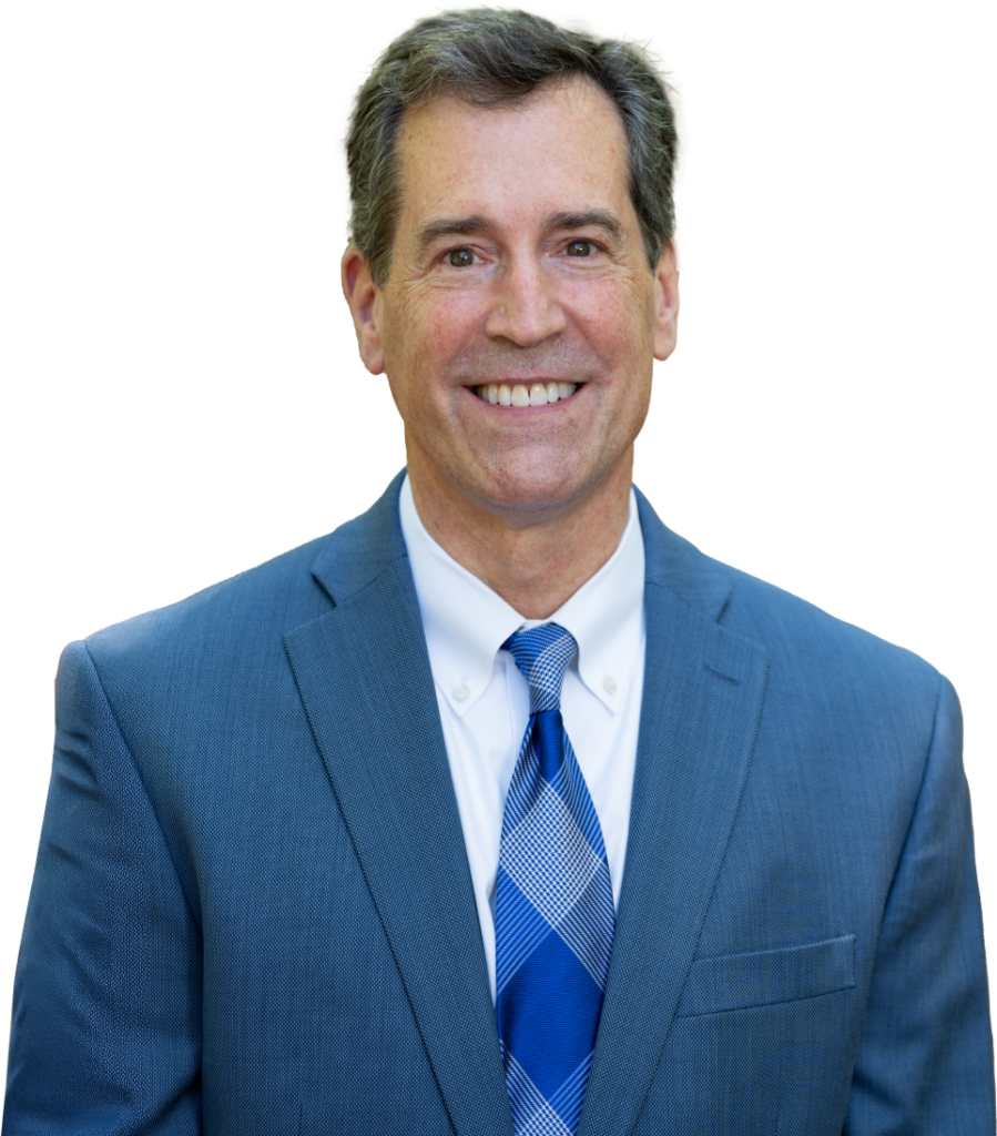 Head shot of Dr. Nordone wearing a blue suit jacket, white dress shirt, and a patterned blue tie