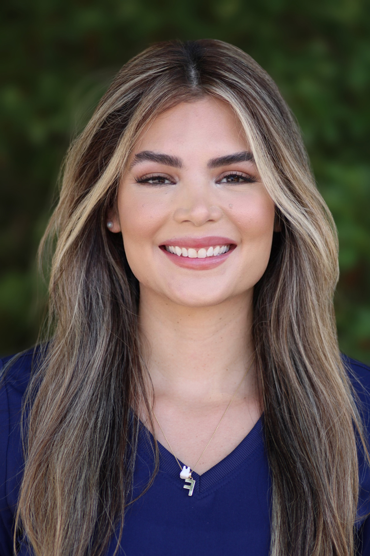 Head shot of Fabiana, Dental Assistant, smiling warmly in blue uniform